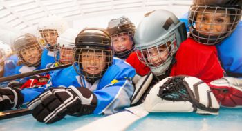 a youth hockey team smiling for a picture
