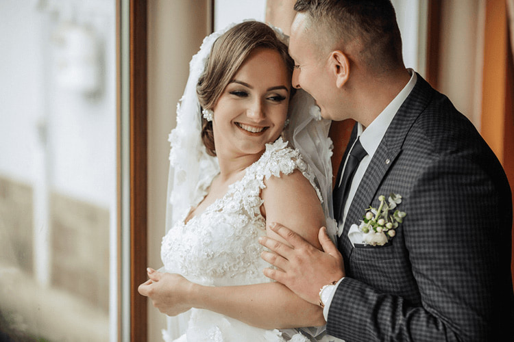 a bride and groom smile together after their wedding