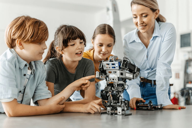 students study a robot with a teacher