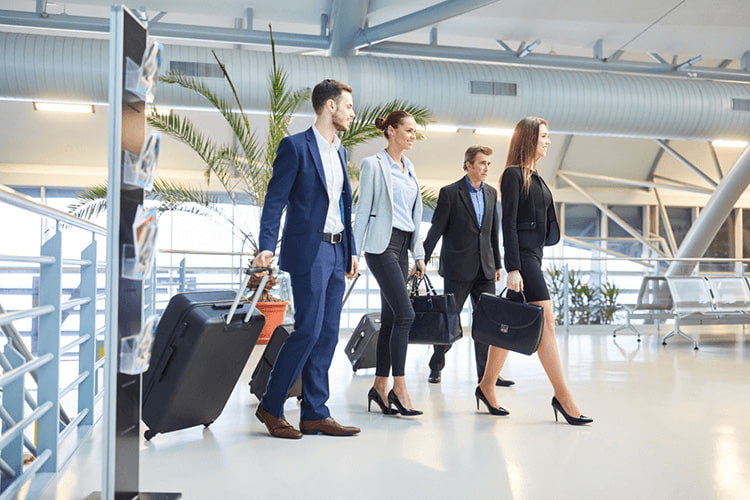 a corporate team walk with suitcases at an airport