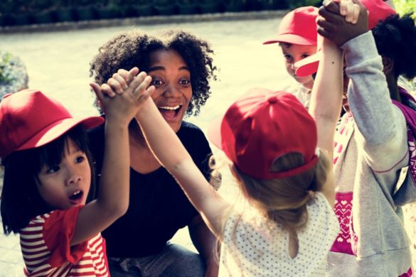a teacher and her students celebrate a win during a field trip
